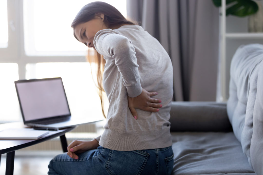 young woman suffer lower back pain