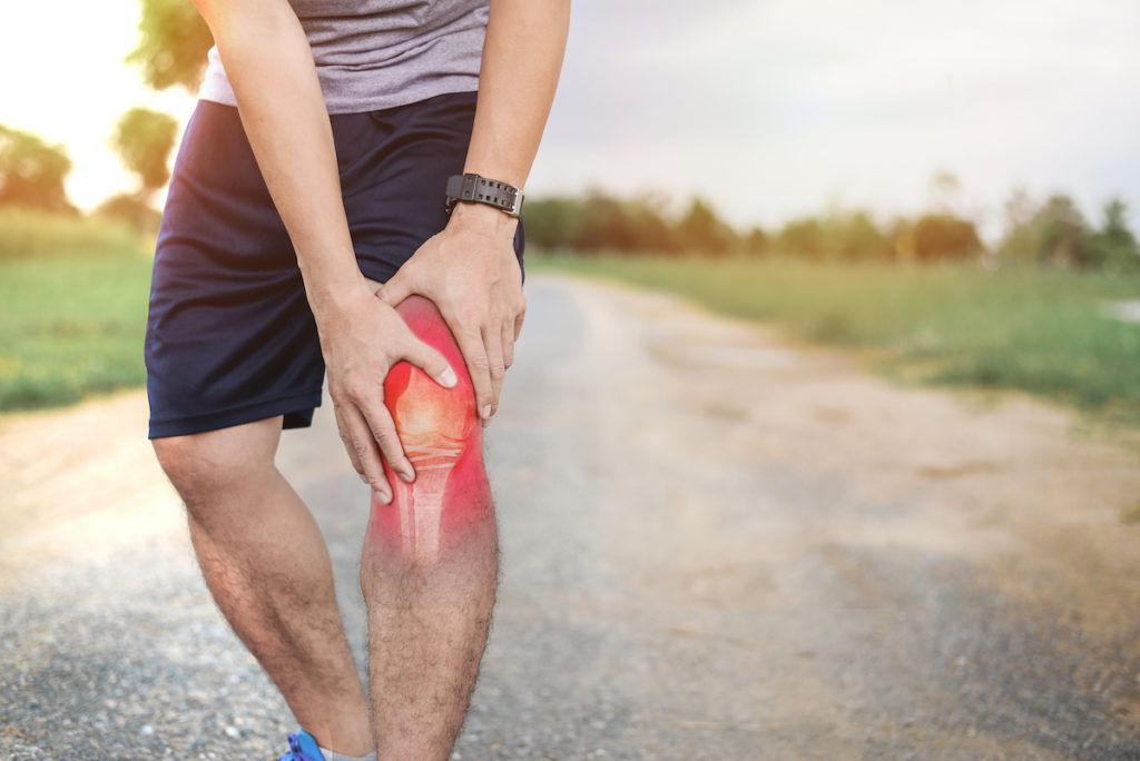 man suffer from sprained knee while on a walk